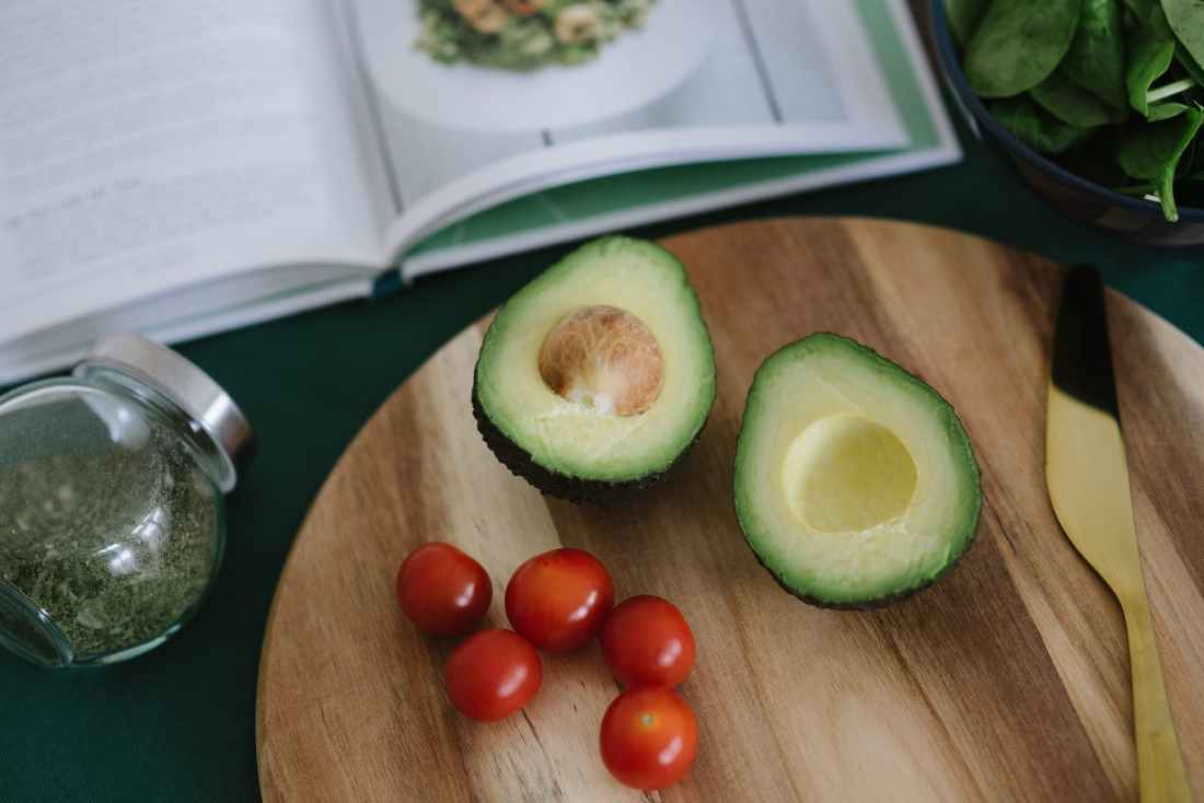 sliced avocado on brown wooden board